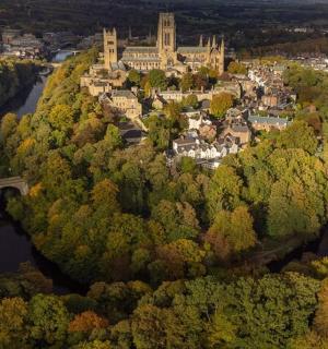 an aerial view of a town with a bridge and a river