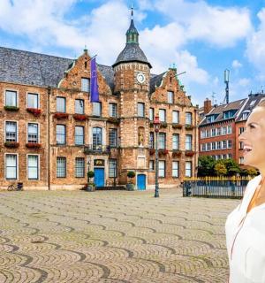 a woman standing in front of a large building