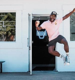 a man jumping in the air in front of a door