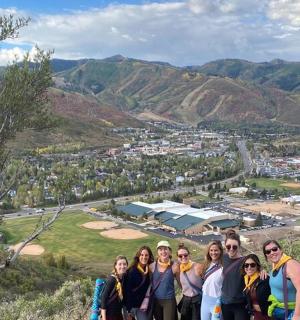 a group of people standing on top of a mountain