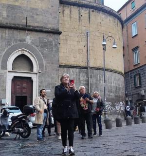 a woman walking down a street in front of a building
