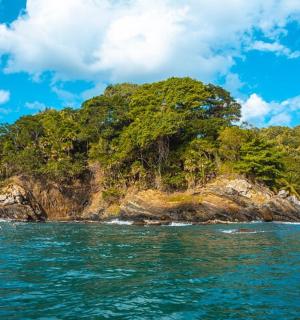 an island in the ocean with a person in the water