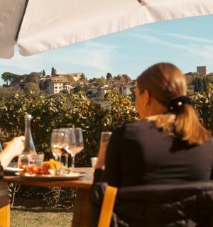 two women sitting at a table with wine glasses