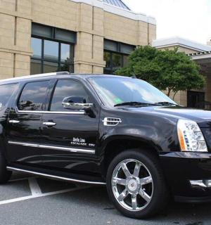 a black suv parked in front of a building