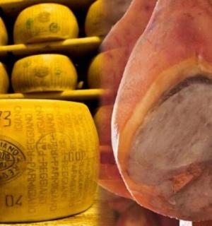 a close up of a ham in front of a bottle of wine