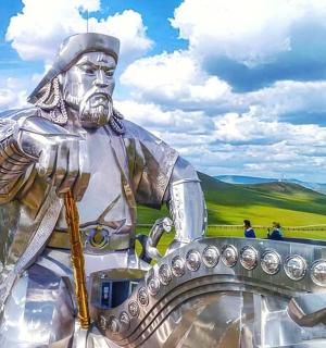 a statue of anubis with people standing around it