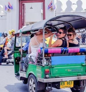 a group of people riding in a golf cart