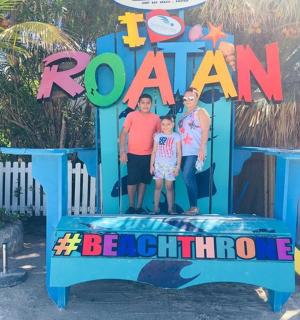 a family poses in front of a sign that says roman be chlorine