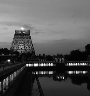 a black and white photo of a lit up temple