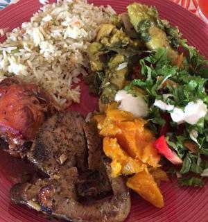 a red plate of food with rice and vegetables