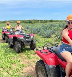 a group of people riding on atvs in a field