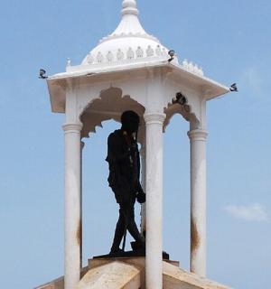 a statue of a man in a white tower