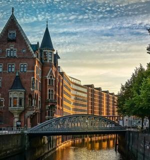a bridge over a river in front of a building