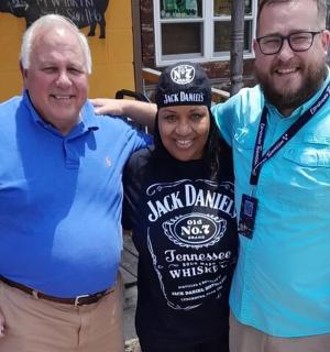 two men and a woman posing for a picture