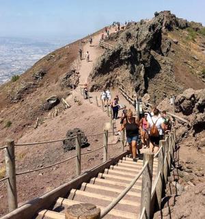 a group of people walking up a mountain