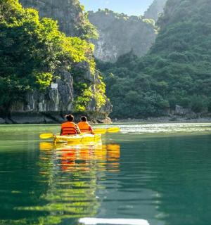 two people in a yellow boat in the water