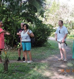 a group of people standing on a dirt road