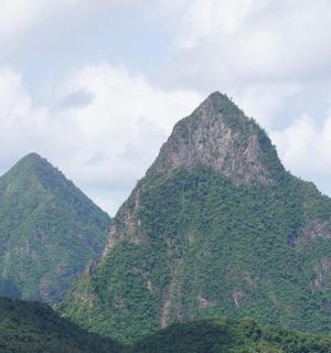 a group of three mountains with trees on them