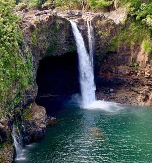 a waterfall in the middle of a pool of water