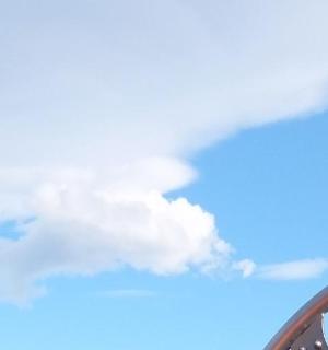 a reflection of a mountain in a rear view mirror