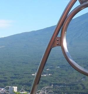 a bell on top of a mountain with a city