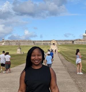 a woman standing in front of a castle