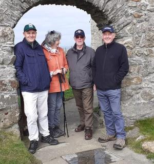 a group of people standing in a stone archway