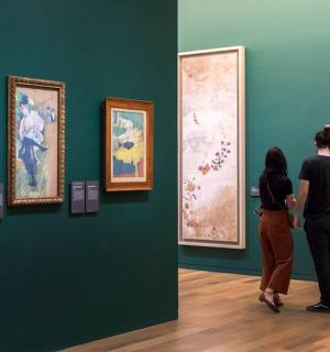 a man and woman looking at art in a museum