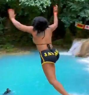 a woman in a bikini standing on a raft in a river