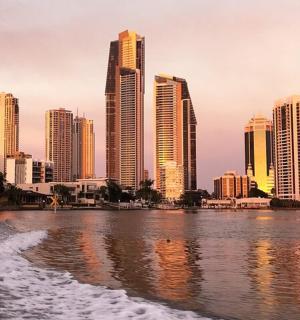 a city skyline with tall buildings and a body of water