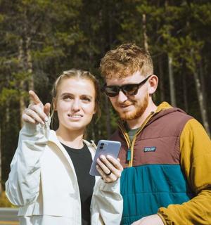 a man and a woman looking at a cell phone