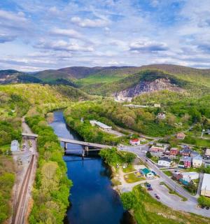 an aerial view of a river with a bridge