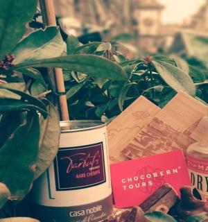 a table with plants and a bottle of essential oils