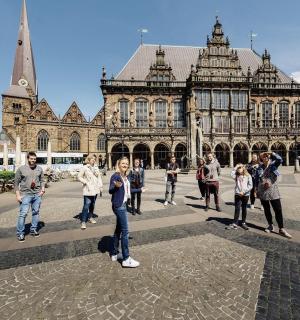 a group of people standing in front of a building