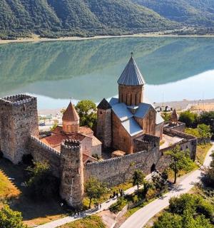 an old castle on the shore of a lake