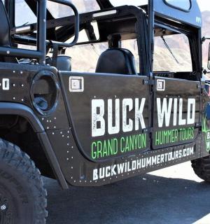 a black jeep with a sign on the side of it