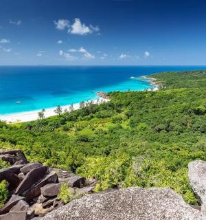 a view of the beach from the top of a mountain