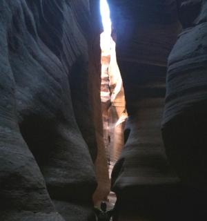 a man standing in a slot canyon