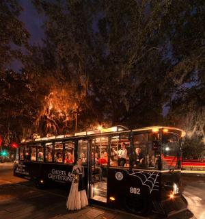 a trolley full of people standing on a wedding