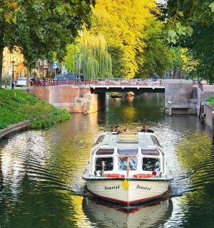 a boat traveling down a canal in a city