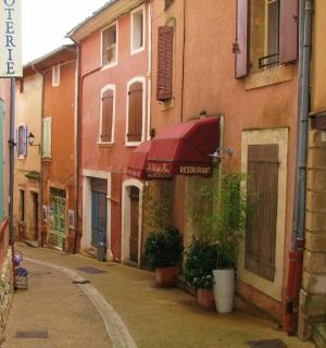 an alley with buildings and a red awning
