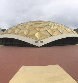 a large building with a dome on top of a parking lot