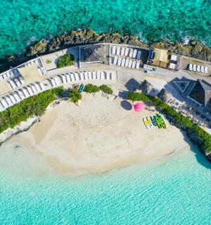 an aerial view of a house on an island in the water