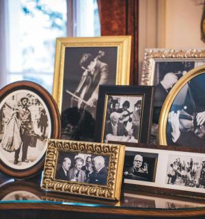 a table topped with photos of people and portraits