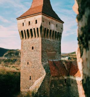 an old castle with a tower with a roof