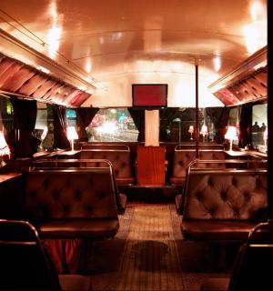 a train car with leather seats and a table and chairs