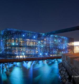 a building lit up with blue lights at night