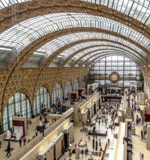 a large building with a glass ceiling and people in it