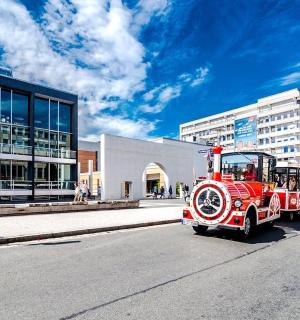an old red fire truck driving down the street
