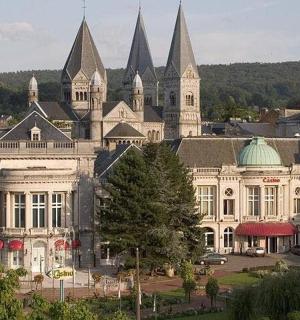 a large white building with pointed roofs in a city